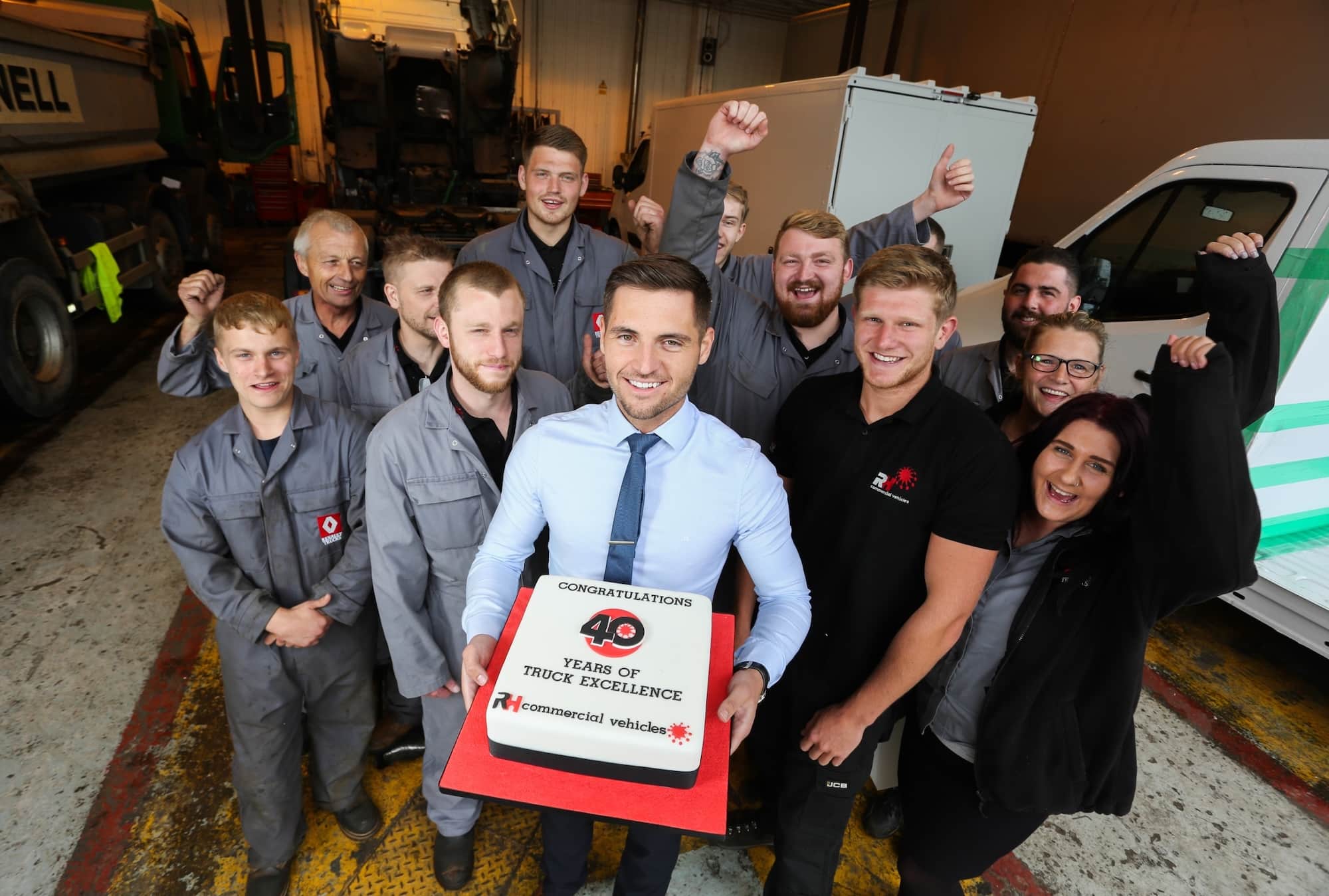 James-Daykin-holding-cake-and-the-team-at-RHCV-in-Cossington