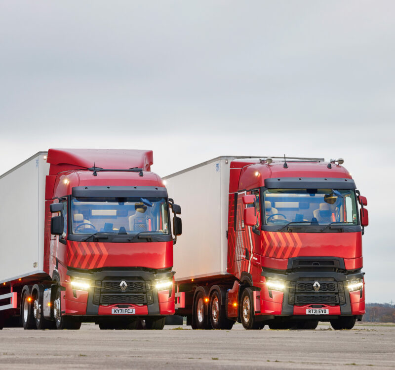 Two, red Renault Trucks parked side by side